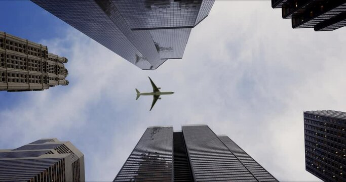 Bottom view of a passenger long-haul aircraft liner flying over skyscrapers in the business center of a large city. Reflections of the plane in the windows of buildings on a sunny day. Travel concept.
