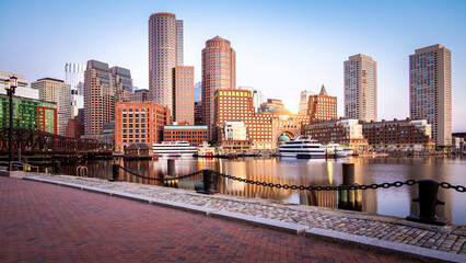 Fototapeta na wymiar Boston in Massachusetts, USA at sunrise showcasing the Boston Harbor and Financial District architecture with skyscrapers and historic buildings.
