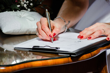 bride is signing a marriage contract