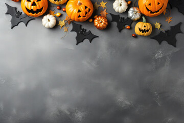 Halloween background with pumpkin and bats on gray background. Top view. Copy space