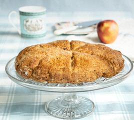 Home baked apple scone presented on a cake stand