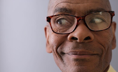 man with reading glasses  on grey background with people stock photo 