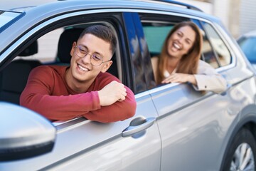 Man and woman mother and son sitting on car at street