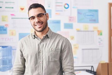 Fototapeta premium Young hispanic man business worker smiling confident at office