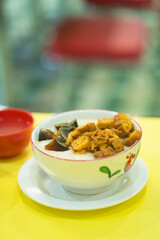 Chinese porridge with phitan egg served in a bowl.