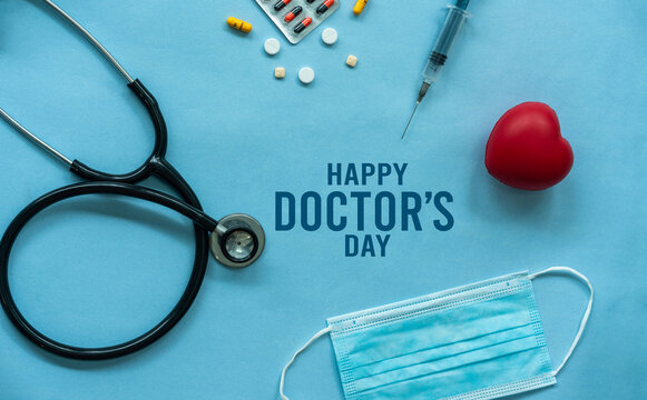 Happy Doctors day concept poster background design, Flat lay image of medical items statoscope face mask syringe and pills isolated on blue colour background