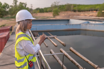 Environmental engineers work at wastewater treatment plants,Water supply engineering working at Water recycling plant for reuse,Technicians and engineers discuss work together.