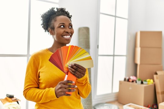 African american woman smiling confident holding color test at new home