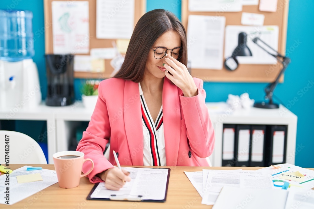 Sticker young hispanic woman working at the office wearing glasses tired rubbing nose and eyes feeling fatig