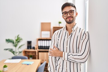 Fototapeta premium Young hispanic man business worker smiling confident at office