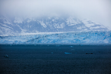 Cruise to Hubbard Glacier Bay in Alaska with floating ice bergs and drift ice floes on ocean water...