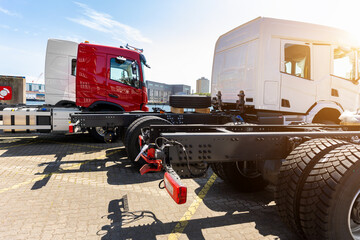 Back view many new heavy commercial cargo transport vehicles stand at port for export import...
