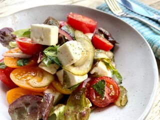 healthy summer salad with tomato fetta basil and onion