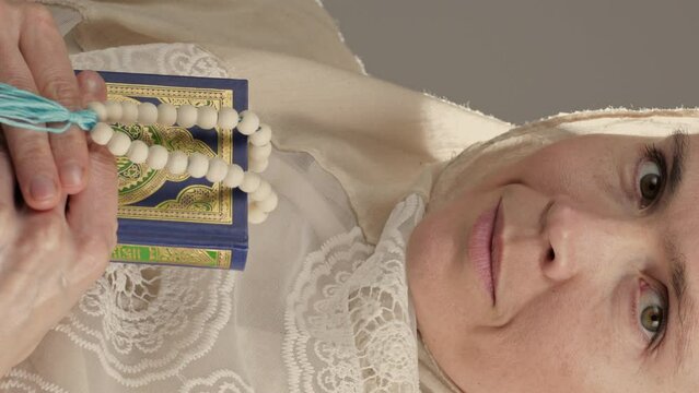 Muslim woman with quran and beads