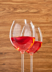 Glasses of delicious sweet berry wine on a wooden background. Romantic date.