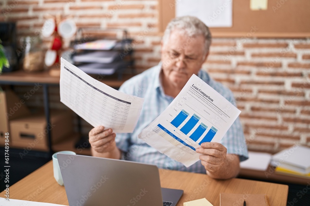 Sticker middle age grey-haired man business worker using laptop reading document at office