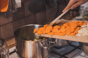 Preparation of homemade broth from carrots and celery. Vegetable soup