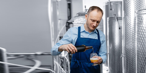 Quality control beer mead, worker tests and evaluates taste of drink at brewery