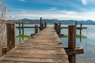 Naklejka premium Small pier at the lake Pfaeffikersee in Zurich in Switzerland