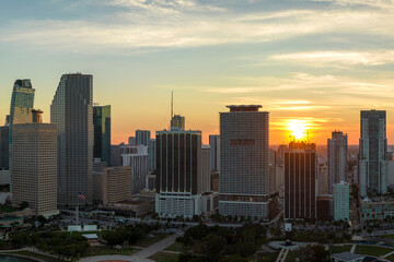 View from above of concrete and glass skyscraper buildings in downtown district of Miami Brickell in Florida, USA at sunset. American megapolis with business financial district at nightfall
