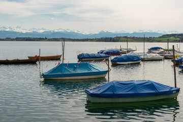 Fototapeta na wymiar Small boats on the lake Pfaeffikersee in Zurich in Switzerland