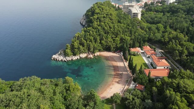 Beautiful Kraljicina beach (Queen's beach) . Summer. Montenegro. Drone. Adriatic sea and beautiful aerial view of Kraljicina beach and Sveti Stefan coast.