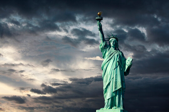 Statue of Liberty on Liberty Island in New York City. Isolated on sunset