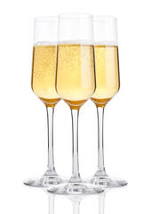 Glasses of champagne with bubbles on white background