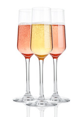 Glasses of champagne with bubbles on white background