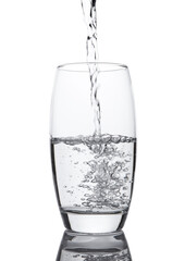 Pouring cold fresh healthy still water to glass on white background