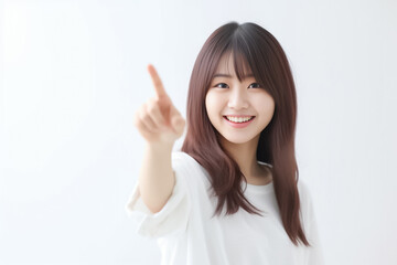 Pointing finger of an Asian girl highlights vacant space on a white background, making it a prime choice for a promotional advertising banner. Generative AI.