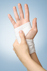 Injured painful hand with white bandage