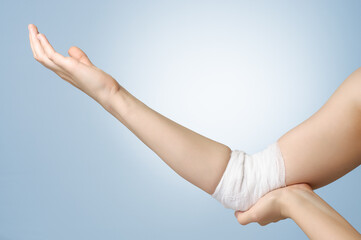 Injured painful elbow with white bandage