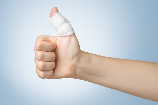 Injured painful finger with white bandage