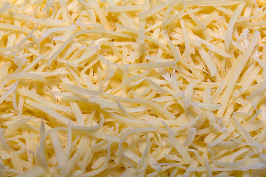 Heap of Grated pizza cheese close up texture