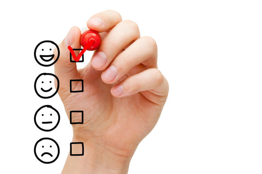 Hand putting red check mark on blank awesome survey checklist next to drawn happy face.