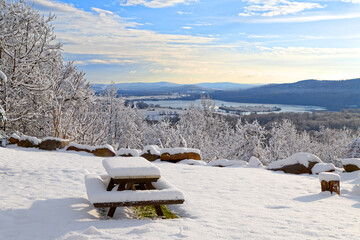 Sunrise on a snow covered mountain with a picnic table in the foreground. Lancaster County, Pennsylvania, USA.