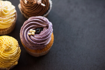 Cupcakes desert cream with space for text on a stone background