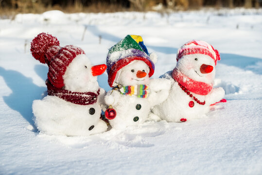 Happy snowman family with hats n the snow