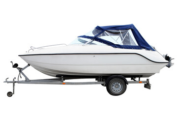 White motor boat with a blue awning loaded on a trailer for transportation.