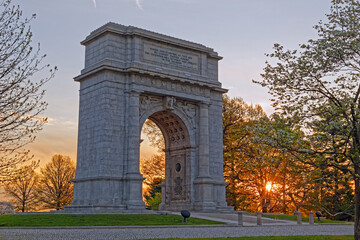 Fototapeta na wymiar A springtime sunrise at Valley Forge National Historical Park in Pennsylvania, USA.The National Memorial Arch is a monument dedicated to George Washington and the United States Continental Army.