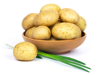 Raw unpeeled potatoes in a wooden bowl and green onions, isolated on white background.