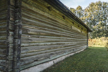 Urban house nestled in nature, with brick and wood architecture under blue sky.