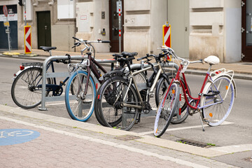Bicycle parking on a city street. A lot of bikes are in a row