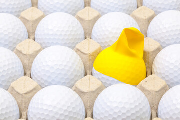 White golf balls in the box for eggs. Golf ball with funny cap.Funny golf concept.