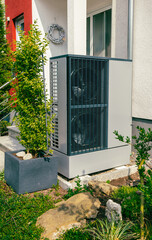 Modern air source heat pump installed outside of new city house