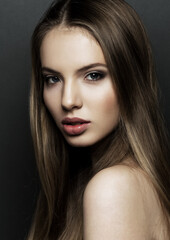 Beautiful woman model portrait with long hair on black background. Red lips