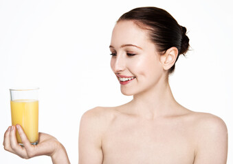 Beautiful woman holding glass with orange juice with white top on white background