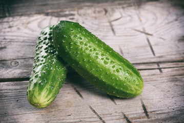 Fresh two cucumbers on rustic wooden table