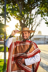 waist up portrait latin American young adult wearing chilean huaso costume on the street 	